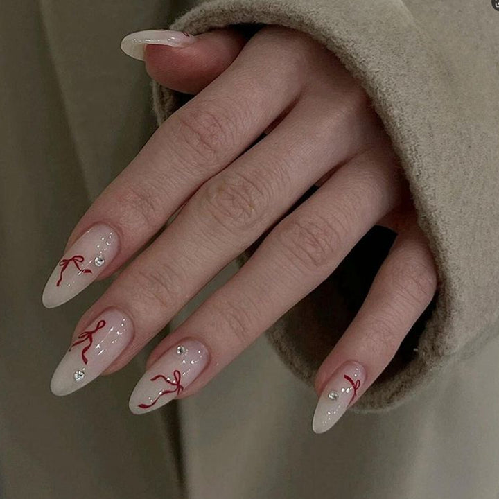 Decorative Stiletto Press-On Nails with Red Ribbon and Gem Embellishments Bowlift