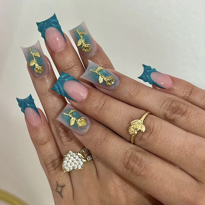 Elegant artificial nail creations with golden embellishments Bowlift