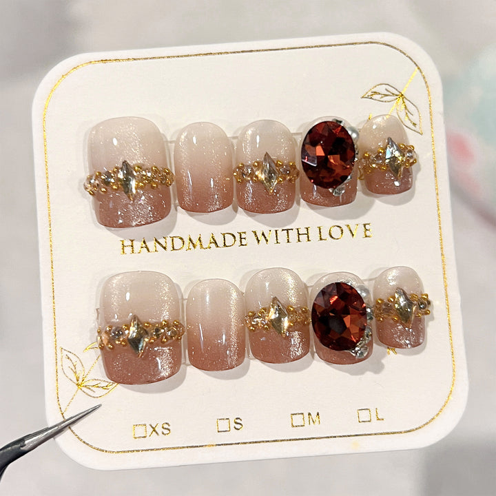 Artificial nail art with glitter and jewelry embellishments Bowlift