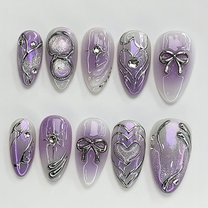 Acrylic nail set with elegant ombre design and delicate embellishments Bowlift