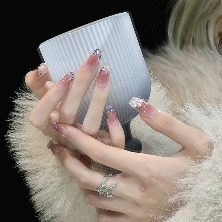 Artificial nail set with glamorous 3D decorations and shimmering accents Bowlift