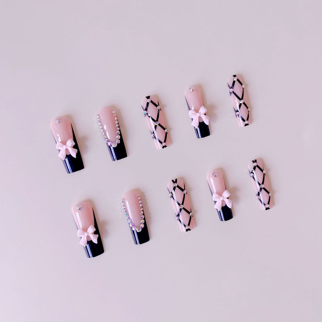 Artificial nail set with glamorous rhinestone and bow accents Bowlift