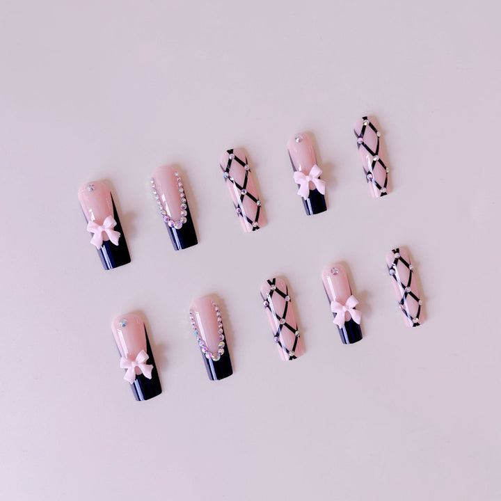 Artificial nail set with glamorous rhinestone and bow accents Bowlift