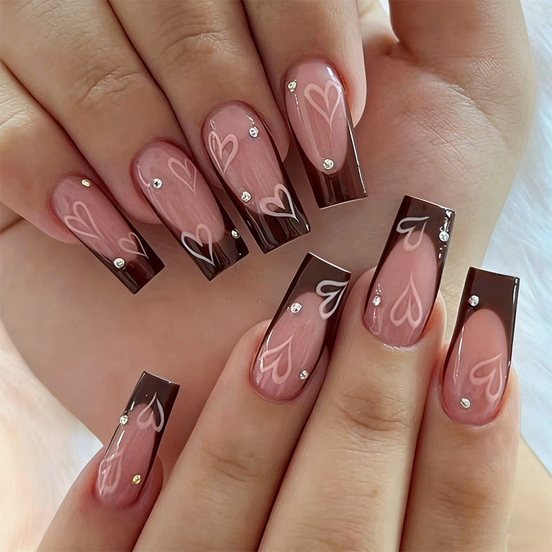Elegant artificial nails with heart pattern and glitter accents Bowlift