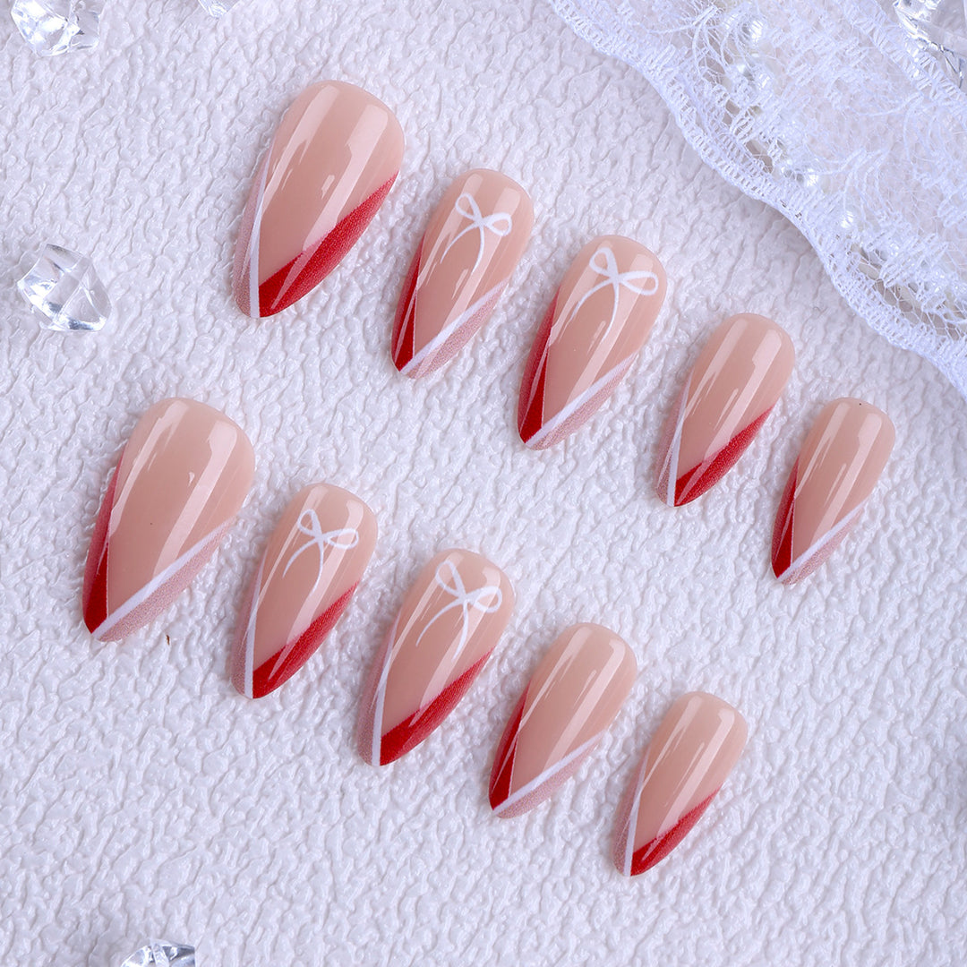 Artificial nails in elegant stiletto design with bow accents Bowlift