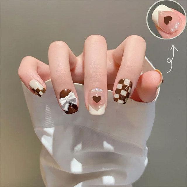 Glamorous artificial nails with heart design and glittering accents Bowlift