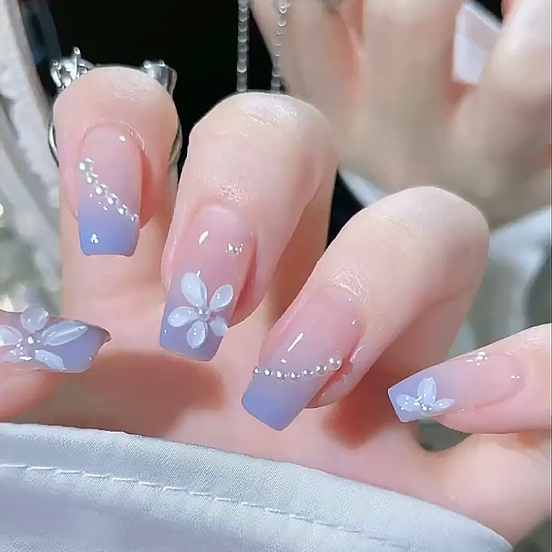 Nail set with elegant floral accents and glitter embellishments Bowlift