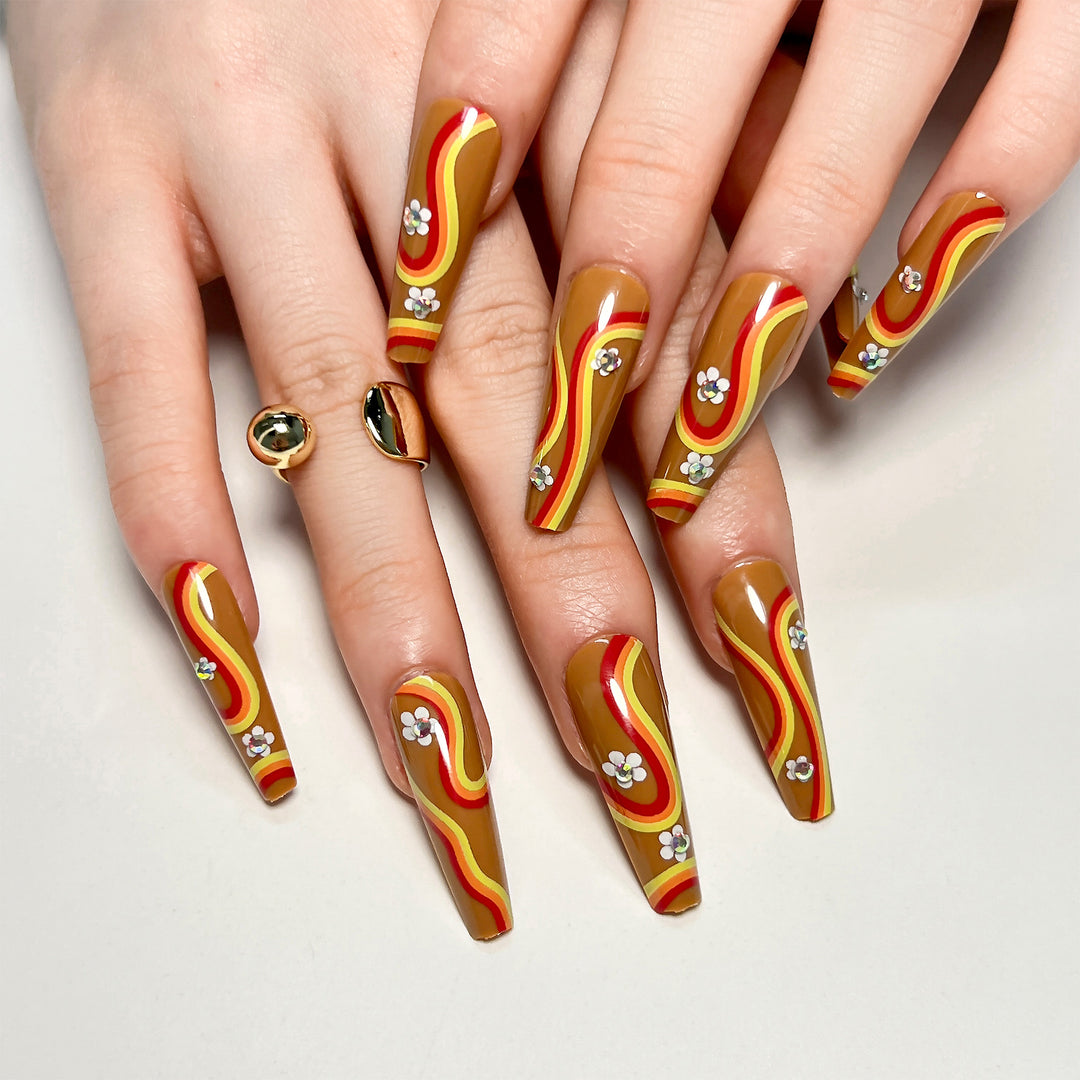 Artful acrylic nails with wave design and floral embellishments Bowlift