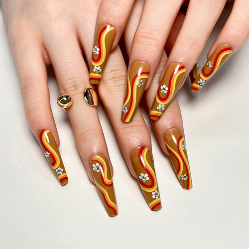 Artful acrylic nails with wave design and floral embellishments Bowlift