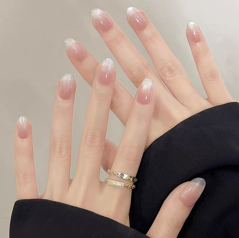 Artistic Press-On Nail Design with Floral and Glitter Accents Bowlift