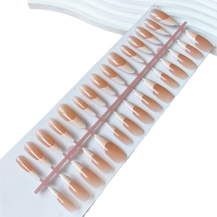 Artificial nails in the elegant French tip design Bowlift