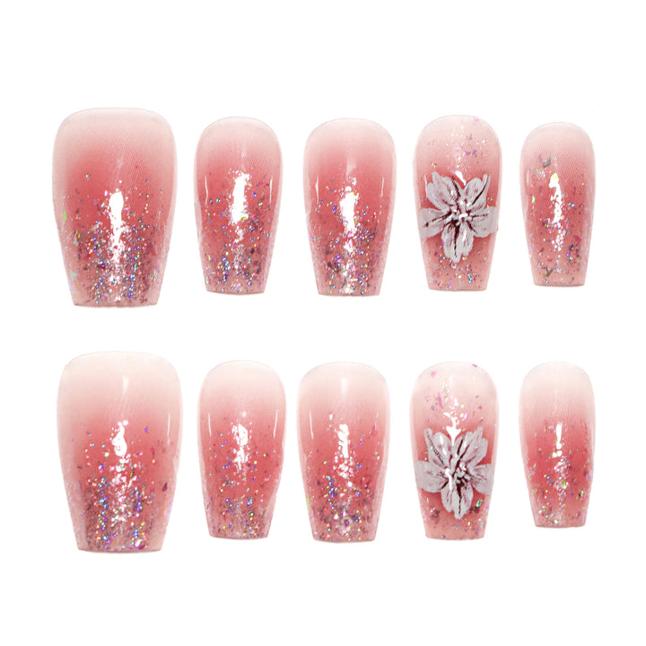 Artificial nail extensions with floral design and glitter accents Bowlift