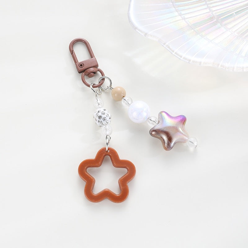 Playful keychain with floral and star motif Bowlift