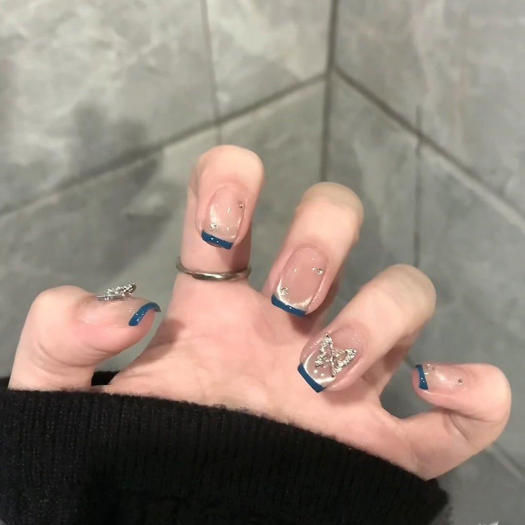 Artificial nails with trendy French tips and decorative glitter accents Bowlift