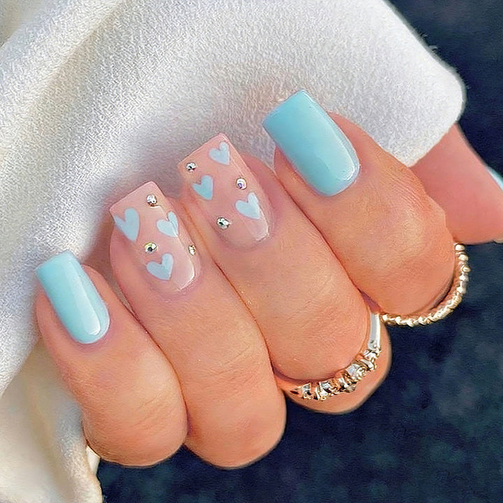 Nail art with heart designs and glitter accents Bowlift