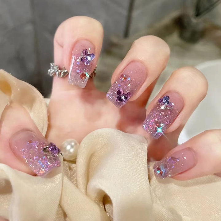 Glamorous artificial nails with glitter and floral accents Bowlift
