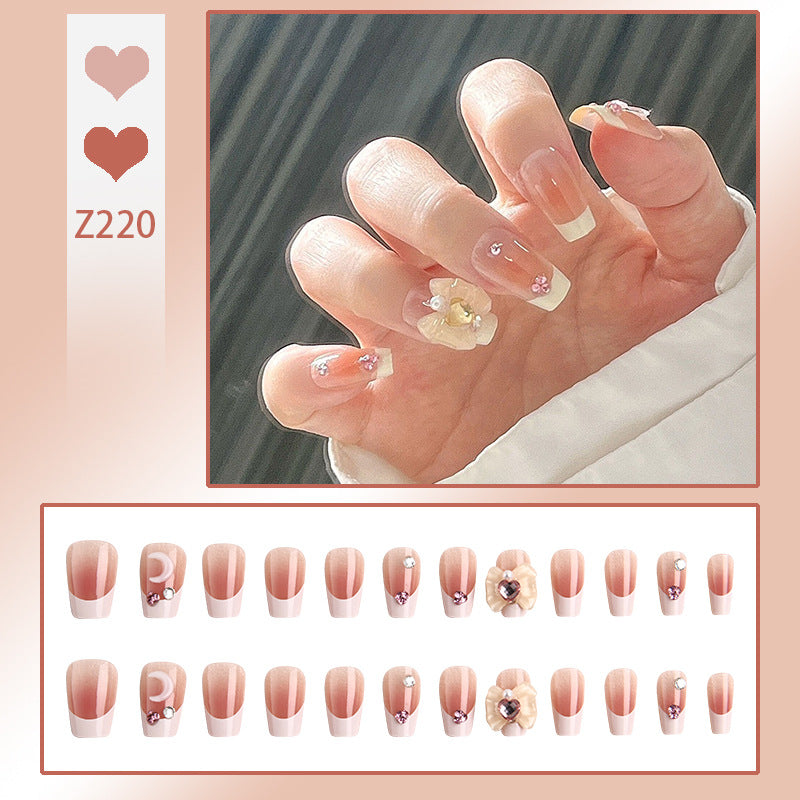 Artificial nail set with elegant floral decorations and glitter accents Bowlift