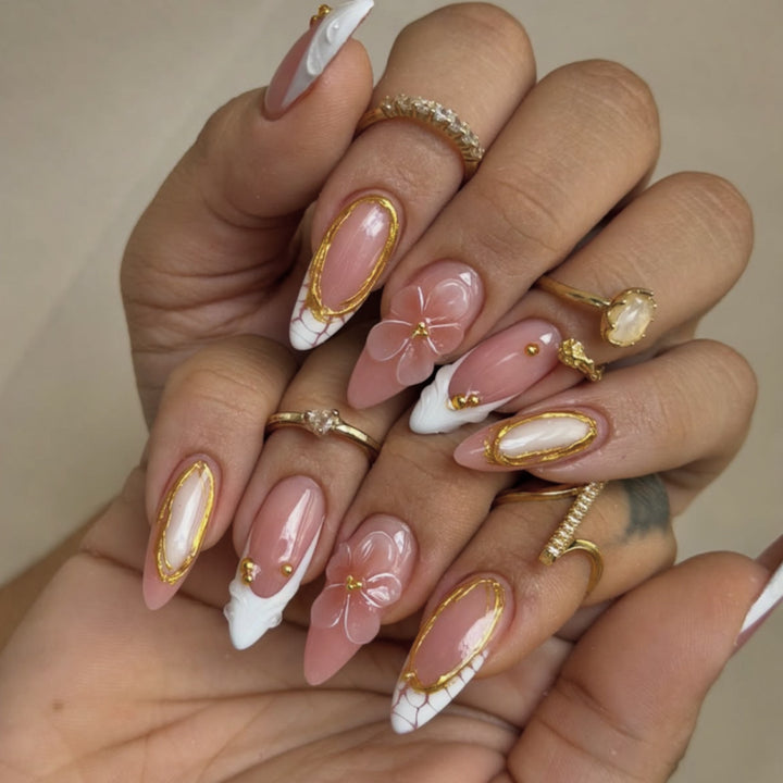 Artful nail art with floral and golden accents Bowlift