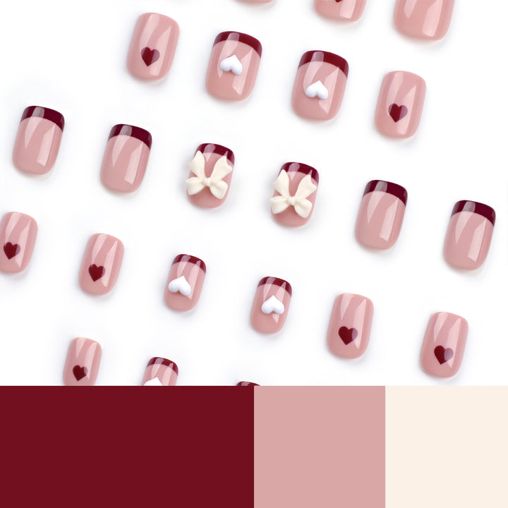 Artful nail art with heart and bow motifs Bowlift