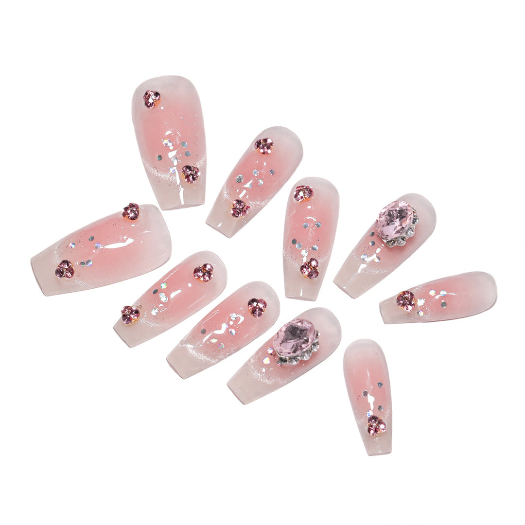 Artificial nail extensions with artistic glitter accents Bowlift
