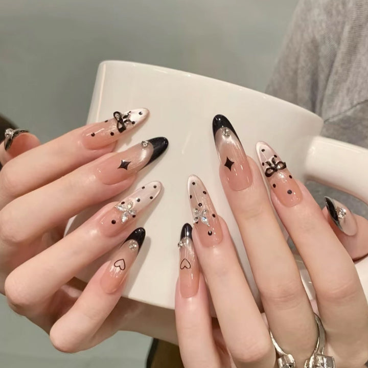 Nail art set with elegant black and white design and sparkling applications Bowlift