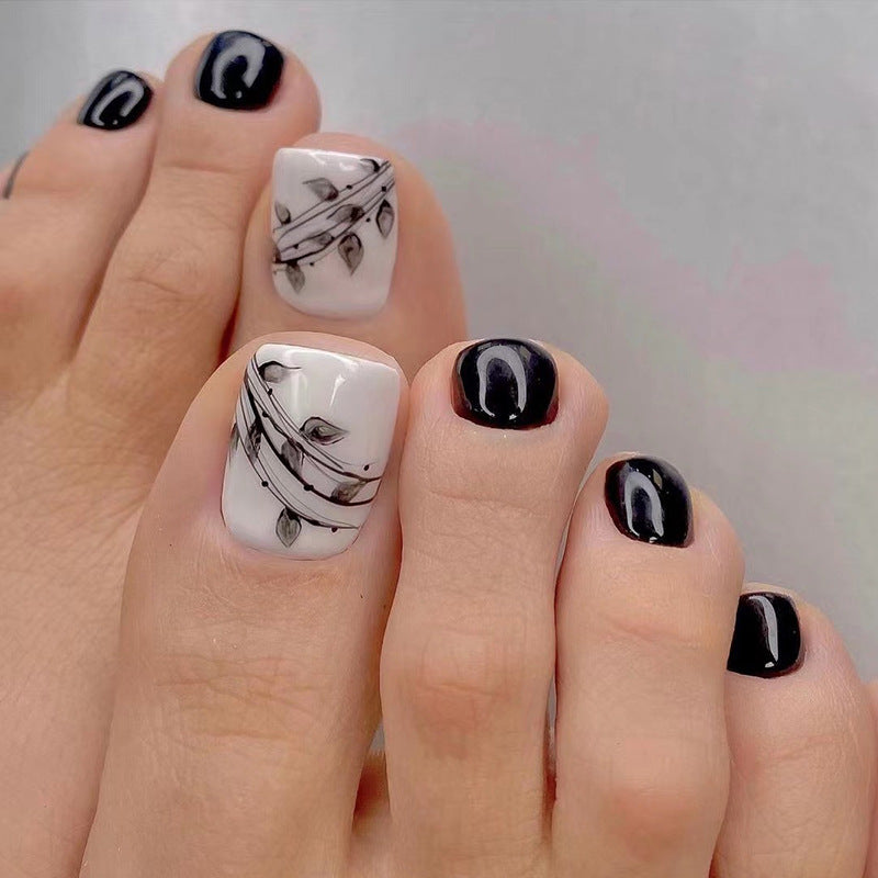 Artful toenail art in elegant black and white design Bowlift