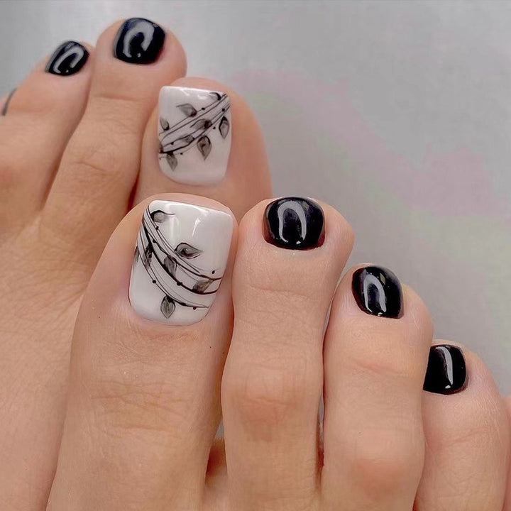 Artful toenail art in elegant black and white design Bowlift