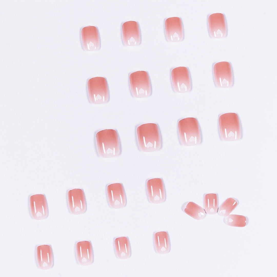 Artful nail art with heart-shaped accents and gentle ombre effect Bowlift
