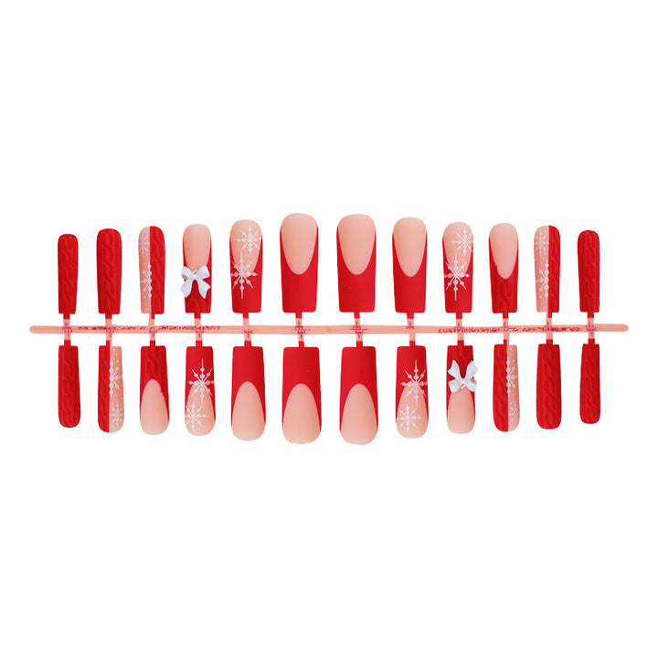 Artificial nail set with festive snowflake and bow motifs Bowlift