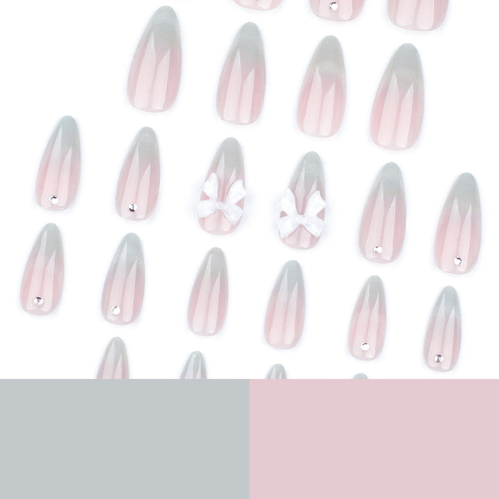 Elegant Stiletto Nails with Glitter and Bow Accents Bowlift