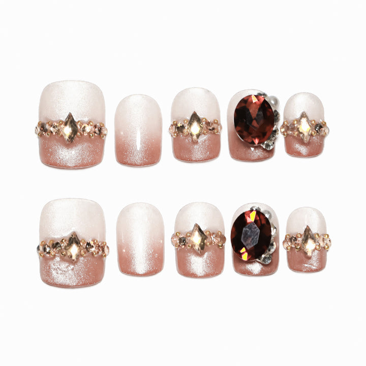 Artificial nail art with glitter and jewelry embellishments Bowlift