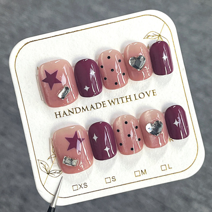 Artificial nail extensions with unique jewelry accents Bowlift