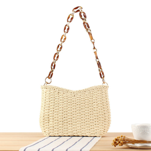Stylish handbag made of woven natural material with exclusive chain accents Bowlift
