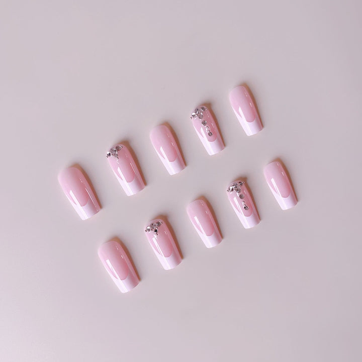 Acrylic nail set with elegant French tips and sparkling rhinestone accents Bowlift