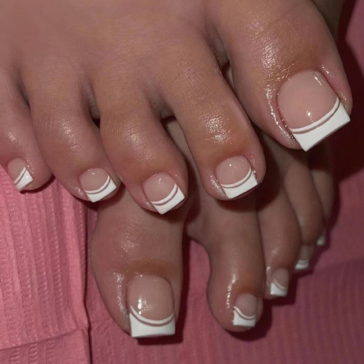 Artful toenail art with elegant French tip design Bowlift