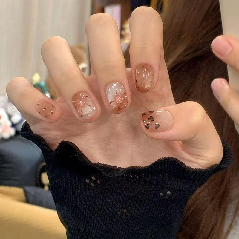 Artificial nail set with festive gift design and elegant glitter accents Bowlift