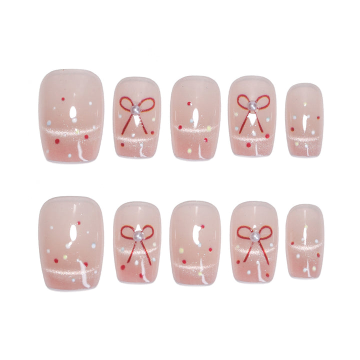 Artificial nail art with elegant bows and glitter accents Bowlift