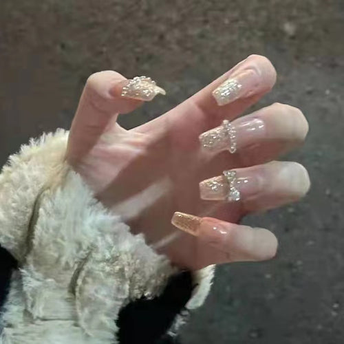 Glamorous artificial nails with sparkling rhinestone and glitter elements Bowlift