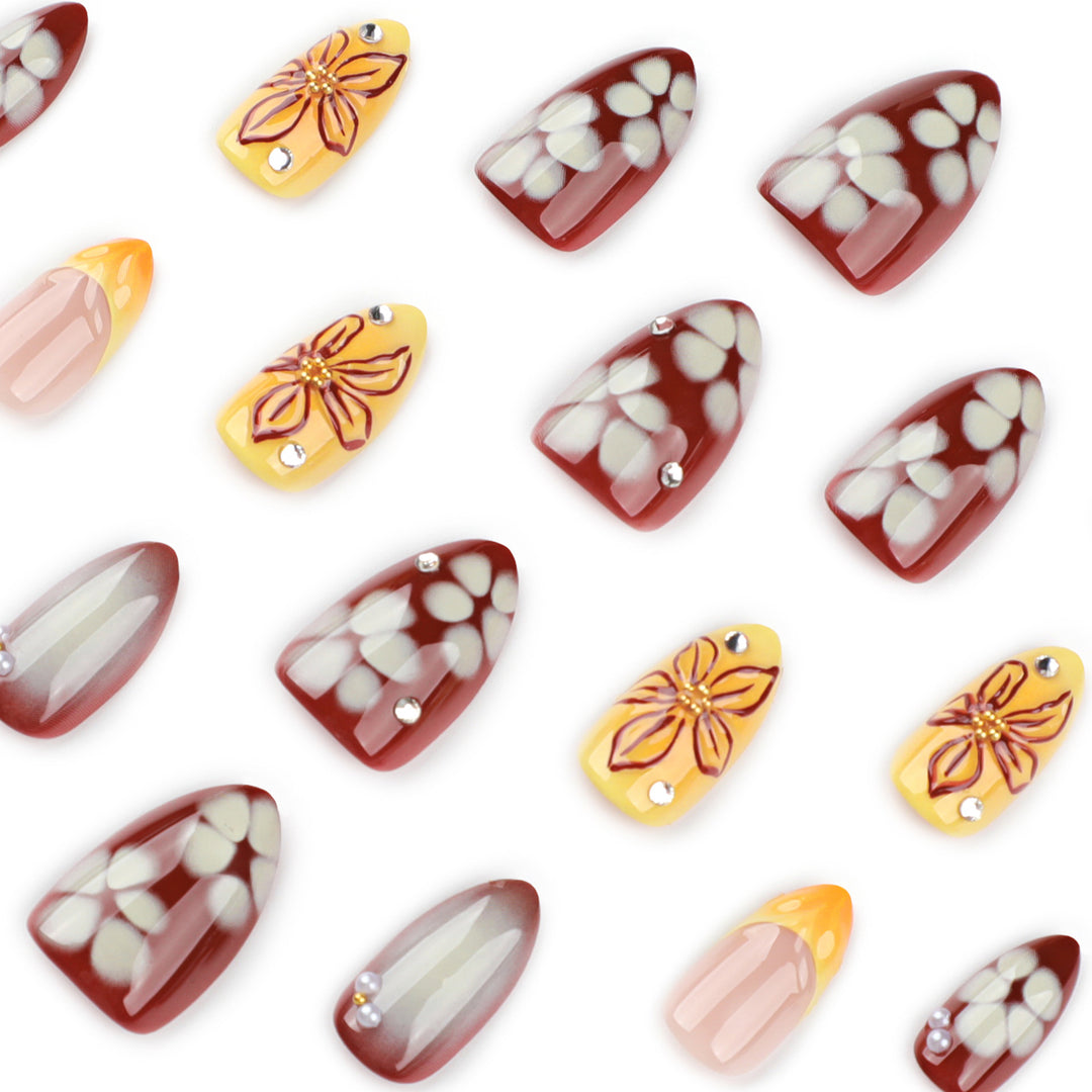 Artificial nail extensions with floral design and rhinestone embellishments Bowlift
