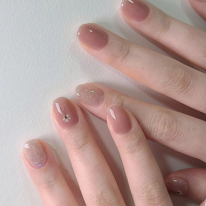 Artificial nails with sparkling accents and floral design Bowlift