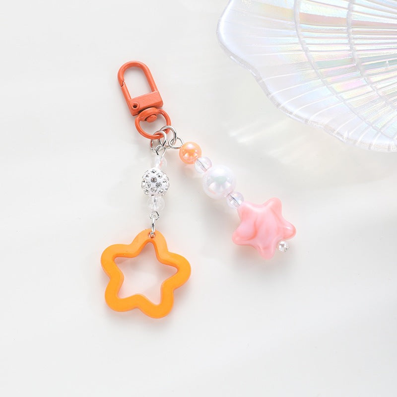 Playful keychain with floral and star motif Bowlift