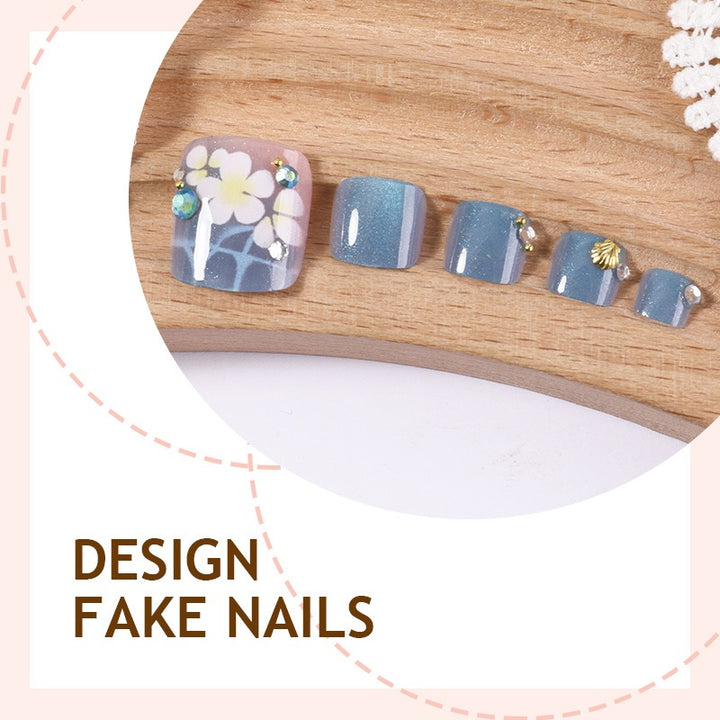 Artificial nail set with floral appliqués and glitter effects Bowlift