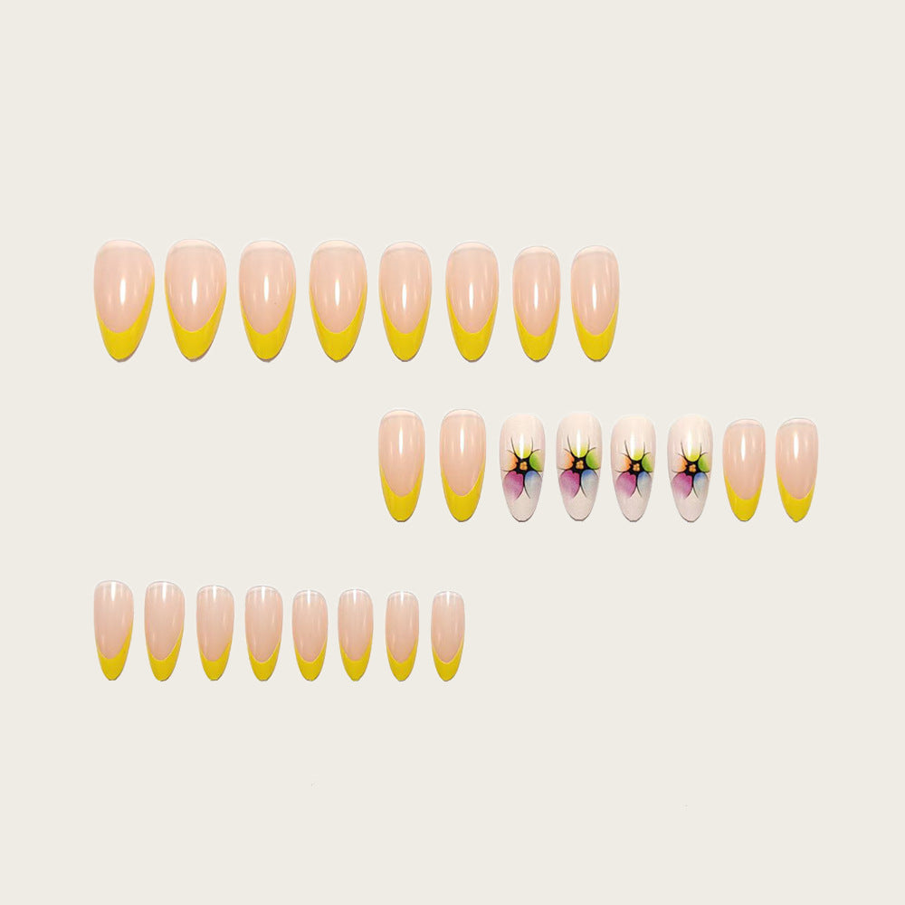 Stylish artificial nails with floral accents and colorful French tip design Bowlift