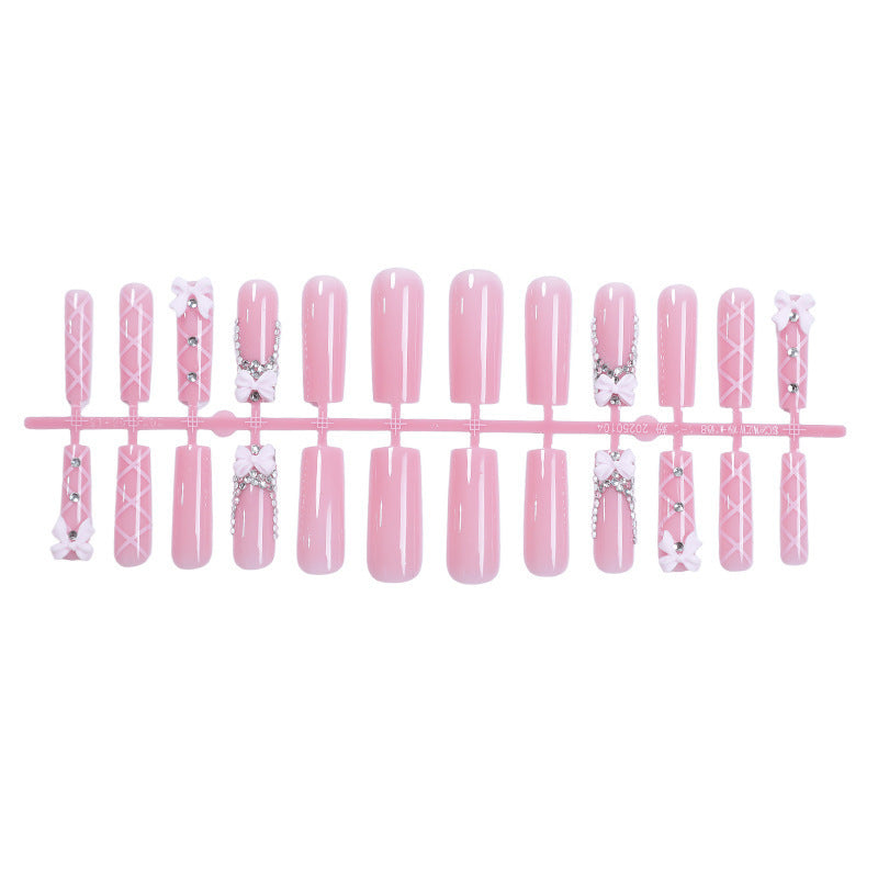 Artificial nail set with romantic bow and glitter accents Bowlift