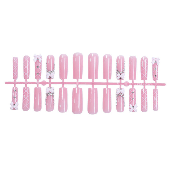 Artificial nail set with romantic bow and glitter accents Bowlift