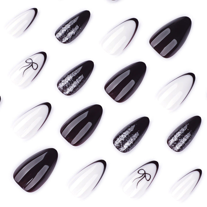 Artful nail art with elegant bow pattern and glitter accents Bowlift