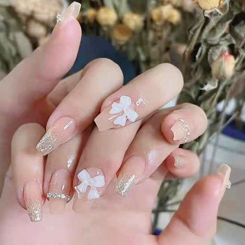 Artificial nails with elegant bow accents and pearl decorations Bowlift
