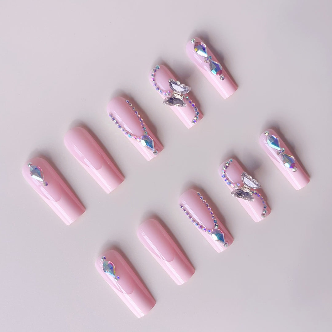 Acrylic nail set with elegant glitter and rhinestone accents Bowlift