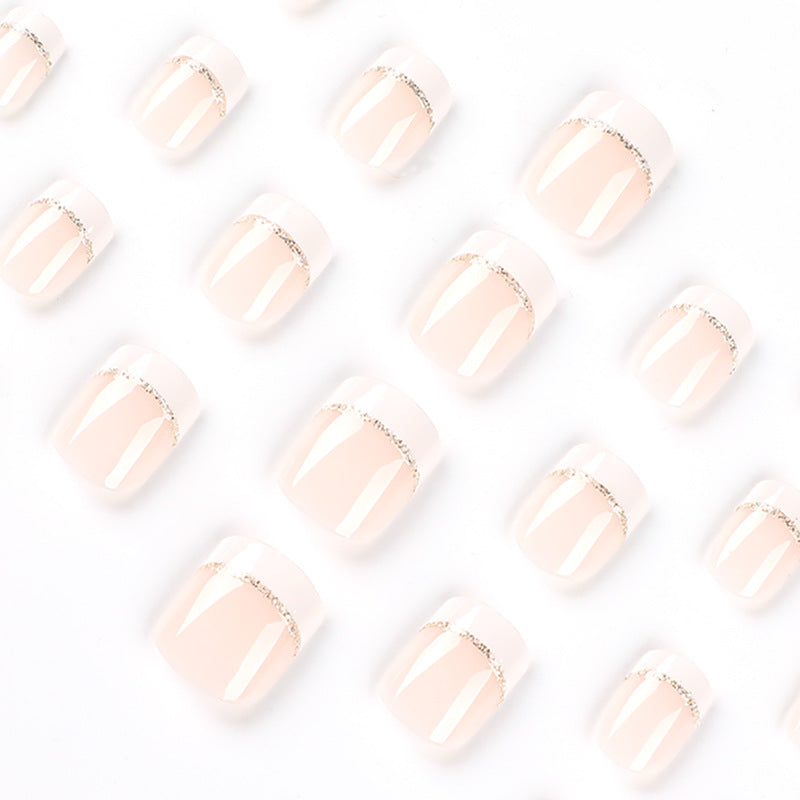 Artful nail extensions with elegant French tip and gold accents Bowlift