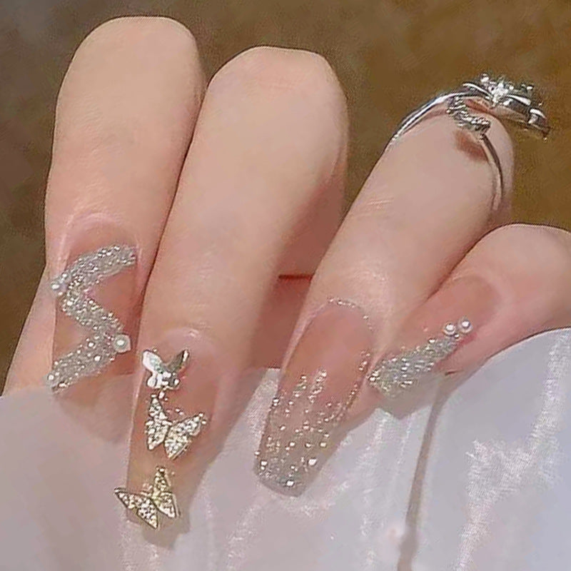 Artificial nails with sparkling rhinestone and bow accents Bowlift
